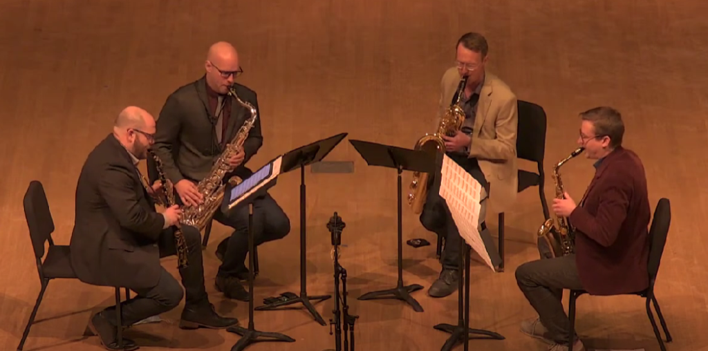 Recording engineer in concert by coalescent saxophone quartet